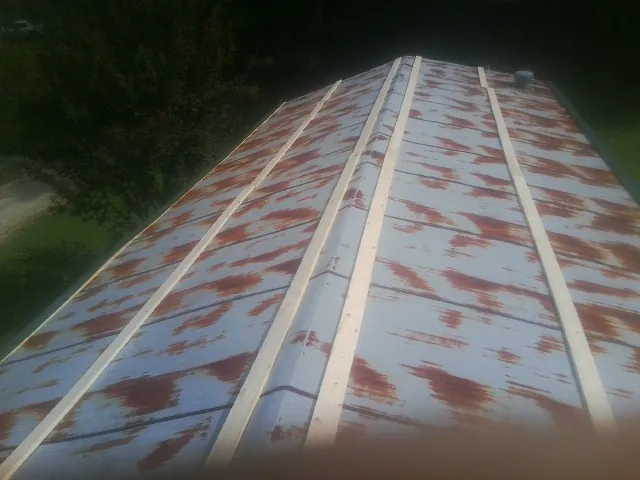 Rusted metal roof panels with new wood purlins before replacement — Storm Damage Roof Repair in Sumterville by Roofing Brothers